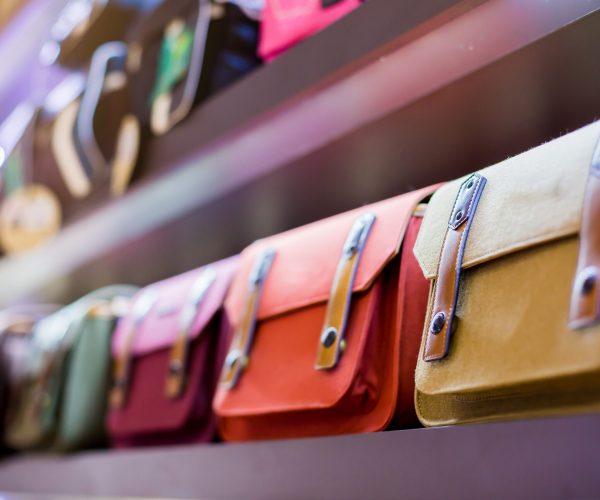 Selective focus to colorful cloth camera bags on the shelf.